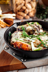 Baked chicken in creamy sauce with green onions