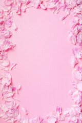 Pink background with peony petals. Top view. Floral print. Abstract blooming texture. Spring concept