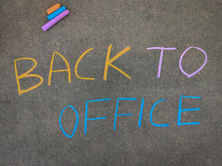 The inscription text on the grey board, BACK TO OFFICE. Using color chalk pieces. Post corona concept