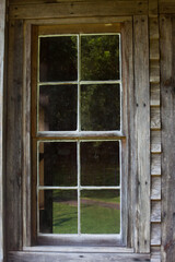 Old window in a wooden wall