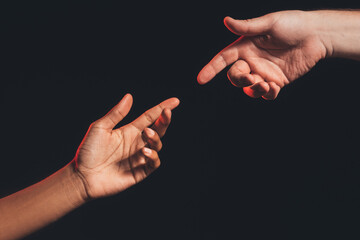 Racial friendship. Help support. Closeup african caucasian male hands reaching out each other...