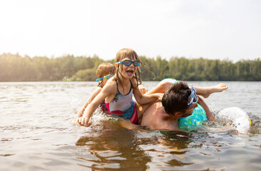 Father and kids having fun in the lake
