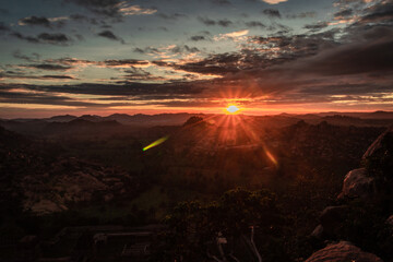 rocky mountain sunrise flares with dramatic sky at morning flat angle shot