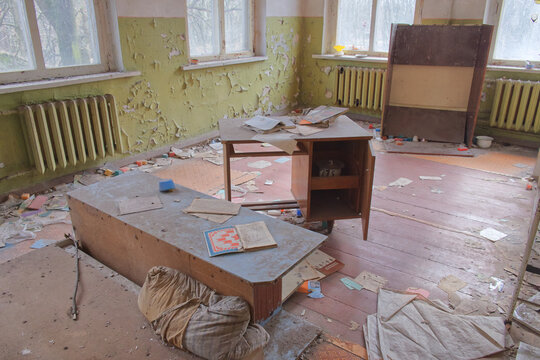 An abandoned kindergarten room in the Chernobyl exclusion zone. Old furniture. Shabby walls and a pile of rubbish on the floor. The interior of an abandoned building.
