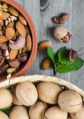 different types of nuts, walnuts on a black and white wooden background top view vertical