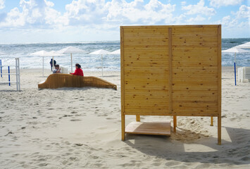 wooden dressing cabin, changing cubicle  on sunny beach on the Baltic sea. Changing room. Kaliningrad region