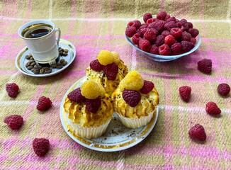 Freshly baked curd muffins with raspberries and a cup of aromatic invigorating coffee.The concept of homemade baking, proper nutrition, agriculture.