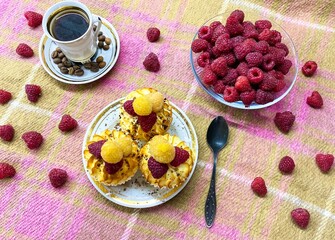 Freshly baked curd muffins with raspberries and a cup of aromatic invigorating coffee.The concept of homemade baking, proper nutrition, agriculture.