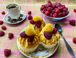 Freshly baked curd muffins with raspberries and a cup of aromatic invigorating coffee.The concept of homemade baking, proper nutrition, agriculture.