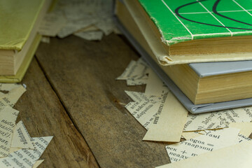 Old books on an old wooden table. Old library. Pieces of paper.