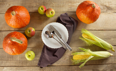 Happy Thanksgiving with pumpkins and leaves, fruits and vegetables on a dark wooden background....