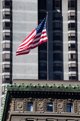 United States Flag with a building in the background