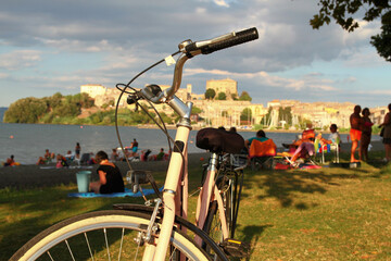 Panorama of the town of Capodimonte Lazio Italy. Bicycle in the foreground. Setting sun.
