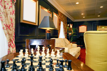 Chess board for playing games in cozy and comfortable living room atmosphere in lounge of luxury...