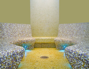 Turkish bath or steam sauna with mosaic tiles inside male locker room of spa or wellness are...