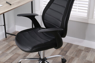 Comfortable office chair near table in room