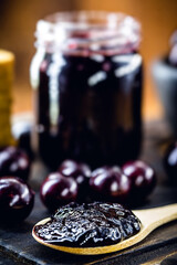 Brazilian grape jam, on a rustic wooden table. Jabuticaba, exotic fruit from Brazil, used in cooking as a sweet.