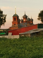 Fototapeta na wymiar Old stone church in the village at sunset