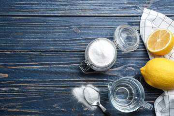 Baking soda and lemons on blue wooden table, flat lay. Space for text