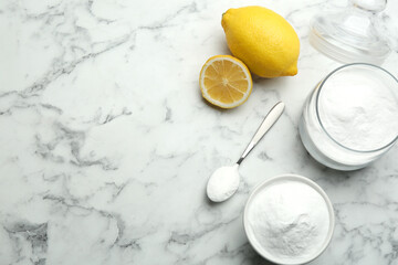 Baking soda and cut lemons on white marble table, flat lay. Space for text