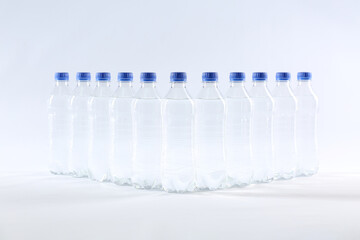 Plastic bottles with pure water on white background