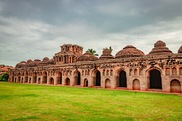 elephant stables hampi antique stone art with green grass floor from unique angle