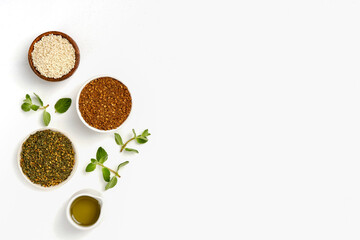 Middle Eastern red and green zaatar spices with fresh zaatar leaves and olive oil. Top view with copy space