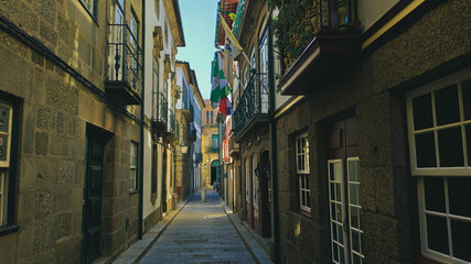 Guimarães street located in the historic center with flags and houses, Portugal.