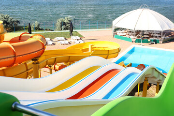 Different colorful slides in water park on sunny day