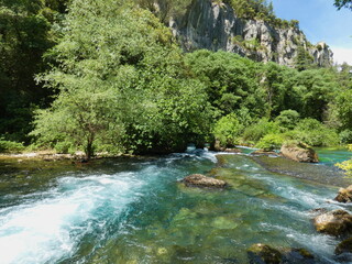 Naklejka na ściany i meble Magnificent landscape of Provence where the Sorgue river flows in a beautiful natural environment at Fontaine de Vaucluse