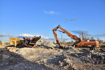High Reach Excavator machines for demolition of tall building. Machine with hydraulic shears for...