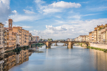Fototapeta na wymiar View of the Arno river and St Trinity bridge designed by Bartolomeo Ammanati and reconstructured after World War II in Florence, Italy