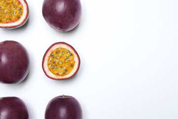 Fresh ripe passion fruits (maracuyas) on white background, flat lay. Space for text