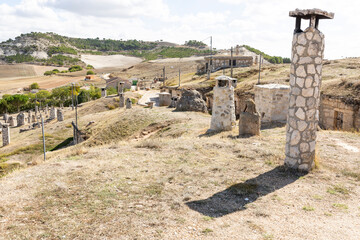 chimneys of underground wine cellars (Bodegas) in Baltanas town, province of Palencia, Castile and...