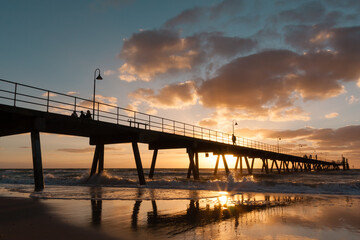 Fototapeta na wymiar Silhouette of Glenelg Jetty at sunset. South Australia, Adelaide. Seaside landscape