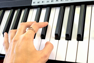 Fingers play chords on synthesizer keys piano playing pianist music