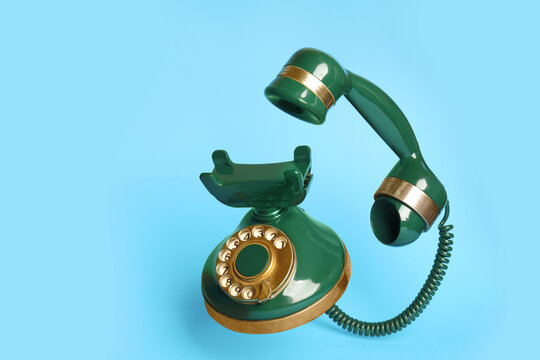 Green Vintage Corded Phone On Light Blue Background