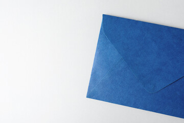 Blue paper envelope on light background, top view. Space for text