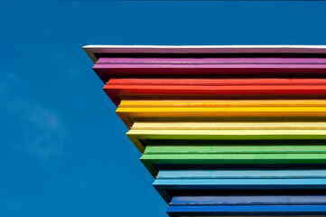 The colors of the rainbow flag against the clear blue sky.  LGBT symbol