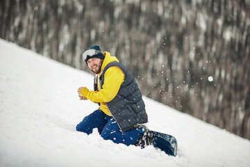 Fototapeta na wymiar Snowboarder sitting on a ski slope