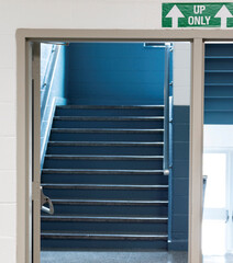 Up only sign at high school stairs to keep students socially distant