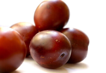 Delicious ripe plum berry dessert on white background raw food