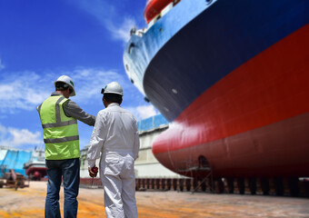 Workers, Engineers discuss ship repair plans On The Dock At The Shipyard with free copy space