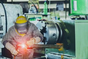 Industrial Worker welding steel pipe line by Tig gass welding
