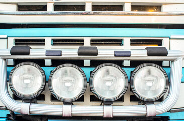 Tractor truck radiator grid protected with bumper-mounted offroad spotlights