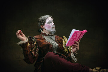 Dear diary. Young man as Johann Bach isolated on dark green background. Retro style, comparison of eras concept. Beautiful male model like historical character, great music composer, old-fashioned.