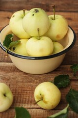 Delicious green apples with leaves on the table