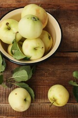 Delicious green apples with leaves on the table