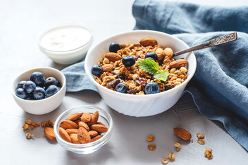 Baked granola with yogurt and blueberries on a gray table. Top view.