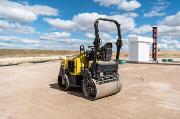 Small steamroller at a construction site, leveling the ground